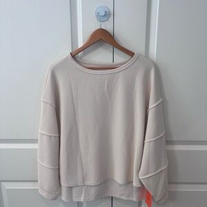 Tankaneo NWT women’s medium beige long sleeve top with high-low hem